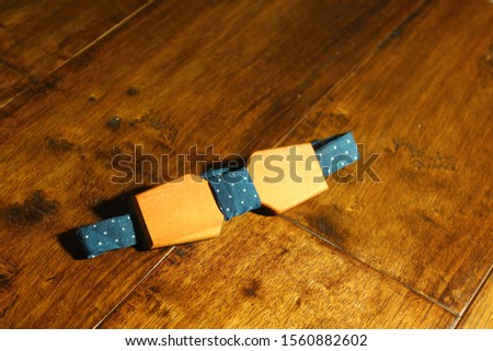 Wooden bow tie with fabric on wooden background fashionable gifts for men