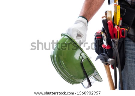 Carpenter isolated on a white background; he wears leather work gloves, he is holding his helmet and protective goggles. Work tools industry construction and do it yourself housework. Text space.