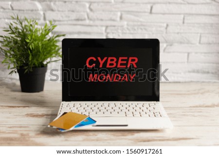 Cyber Monday sign and laptop computer with credit cards. Holiday online shopping concept.
