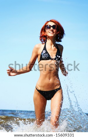 beautiful girl running on the sea