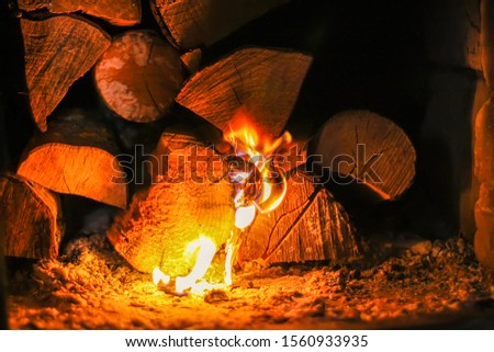 Hot flame and firewood in old stove in the village.