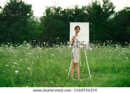 young slender woman on a white canvas paints