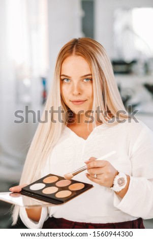 Caucasian woman blogger creating beauty video blog. Female makeup artist recording cosmetics apply tips. Smiling blond lady freelance visagist. 