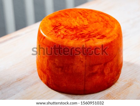Picture of tasty french goat cheese with pepper at wooden desk