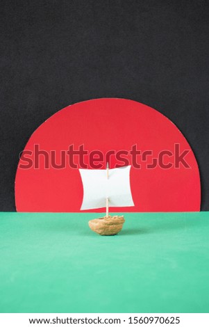 Walnut ship on a black, red and green  background