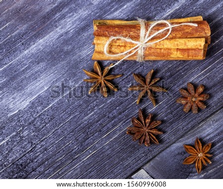 cinnamon and star anise on a dark wooden surface top view, seasoning for wine and mulled wine for new year and Christmas. Christmas copy space for your text and information, recipe and object.
