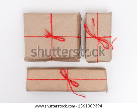 Wrapped vintage gift boxes with red ribbon . Top view