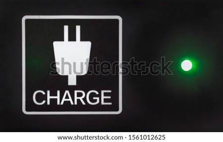 Free public mobile charge sign with a green light.