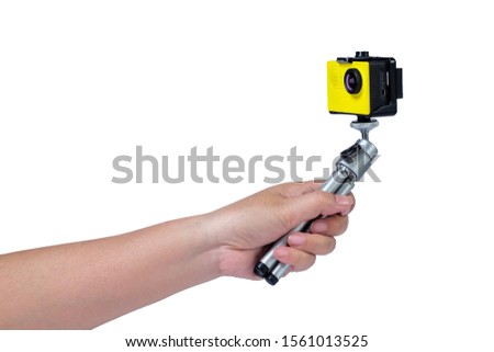 Action camera on mini tripod in hand with white background.