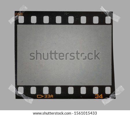 cool photo placeholder for your content, real 35mm film frame or strip with sticky tape on edges.