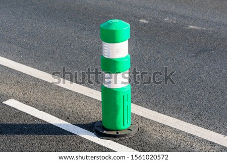 Green post installed on protected bikeway, bike lane or route makes it safer to bicycle by separating bicyclists from motorized traffic 