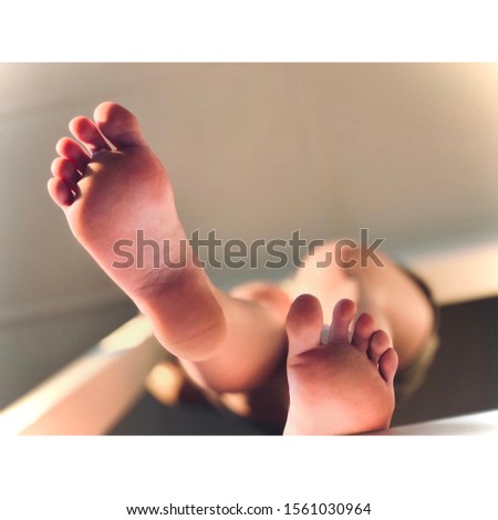 Feet stepping from above almost appearing as if they will tread on the audience Royalty-Free Stock Photo #1561030964