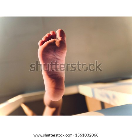 One foot stepping out showing full sole underneath Royalty-Free Stock Photo #1561032068