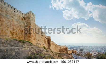 Wall of Naryn-Kala fortress View of Derbent city. Republic of Dagestan, Russia Royalty-Free Stock Photo #1561037147