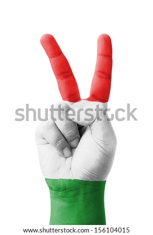 Hand making the V sign, Hungary flag painted as symbol of victory, win, success - isolated on white background
