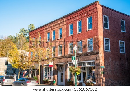 Traditional American brick buildings with stores at the street level on a sunny autumn day. Woodstock, VT, USA.