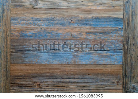 Background of an old wooden wall with remains of paint.