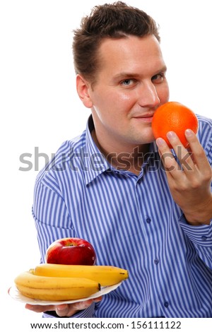  young man with fruits on white background concept of healthy nutrition