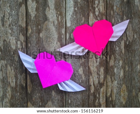 origami heart on wooden background 
