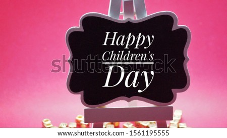 Happy childrens day on black writing board.