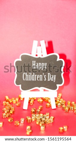 Happy childrens day on black writing board.