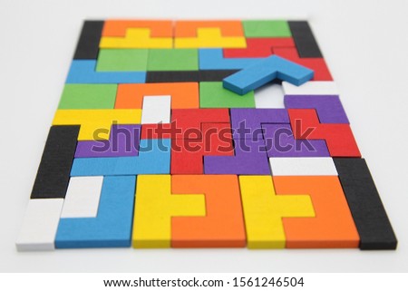 Different colorful shapes wooden blocks.Geometric shapes in different colors. Concept of creative, logical thinking or problem solving.Geometric shapes on wooden background.Tetris toy wooden blocks.