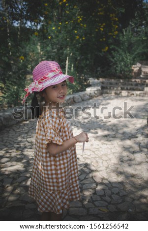 Beautiful happy smiling little girl  with wearing hat
