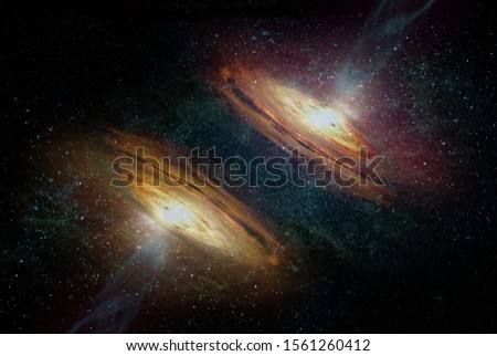 Space background with two symmetrical twins spiral galaxy and stars. Elements of this image furnished by NASA. Royalty-Free Stock Photo #1561260412