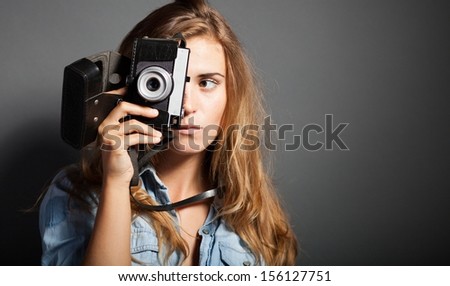 Silly photographer woman taking pictures with old camera
