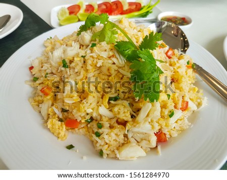 Crab meat fried rice served on a white plate at a street restaurant in Bangkok, Thailand Royalty-Free Stock Photo #1561284970