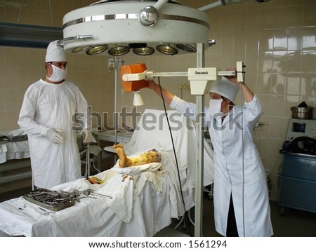 A surgical procedure in an operating room. X-ray examination