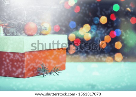Image of handmade gift boxes over snowy wooden table