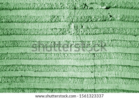 Grungy cement wall texture in green tone. Abstract background and pattern for design.