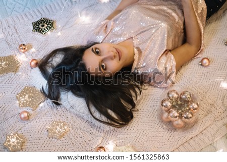Top view of woman lying on the Christmas decorated floor