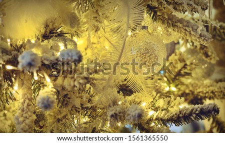 Closeup of white bauble hanging from decorated Christmas tree with bokeh, copy space, Christmas holiday background.Two thousand twenty. 2020