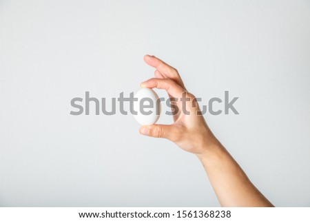 Woman hand with hen egg isolated on white background.to pick an egg.