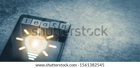 Cube letter word of Learn with tablet and light bulb and futuristic icon with copy space. Photo concept of online course of business and education, academic and literature long distance e-learning