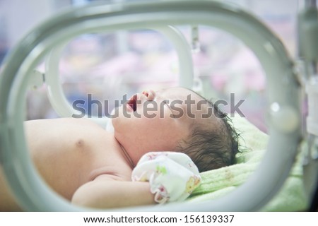 newborn baby in Incubator care at nursery Royalty-Free Stock Photo #156139337