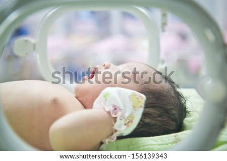 newborn baby in Incubator care at nursery Royalty-Free Stock Photo #156139343