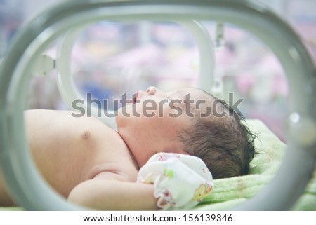 newborn baby in Incubator care at nursery Royalty-Free Stock Photo #156139346