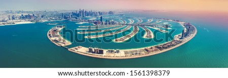 Aerial view on Palm Jumeira island in Dubai, UAE, on a summer day. Royalty-Free Stock Photo #1561398379