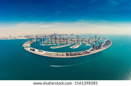 Aerial view on Palm Jumeira island in Dubai, UAE, on a summer day. Royalty-Free Stock Photo #1561398385