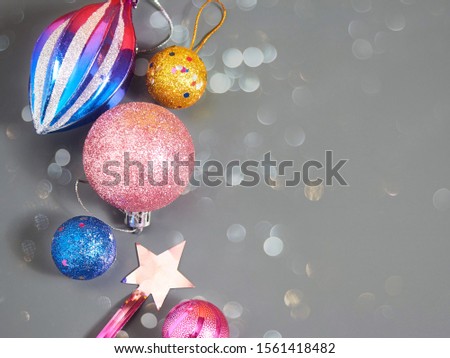 Shiny balls lie on a gray background, a picture with highlights for a design with an empty space.