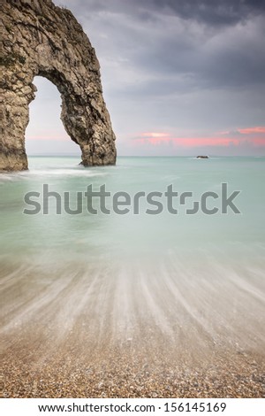 Durdle Door is a natural limestone arch on the Jurassic Coast near Lulworth in Dorset, England.   The arch has formed on a concordant coastline where bands of rock run parallel to the shoreline.