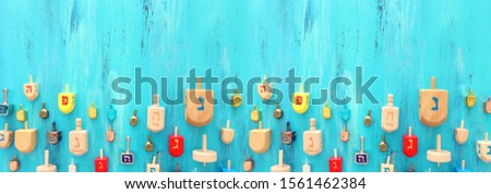 religion concept of jewish holiday Hanukkah with dreidels colection (spinning top) over blue background