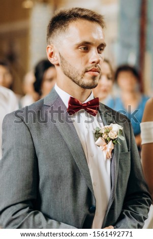Wedding ceremony in church. Portrait of groom during marriage