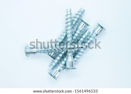 Silver screws located on a white background