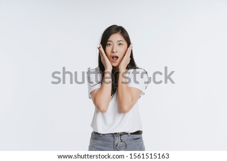 Beautiful black long hair young Asian woman, Girl feeling very happy amazed excited and surprised, studio light portrait shot isolated on white background. in a summer t-shirt Short jeans. Copy space 