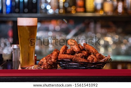 A picture of chicken wings and beer