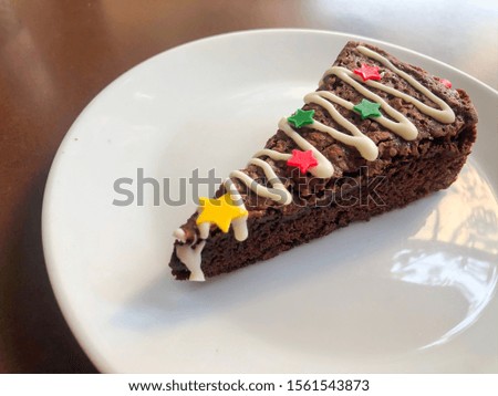 Christmas Tree Chocolate Brownie on black table background with copy space.